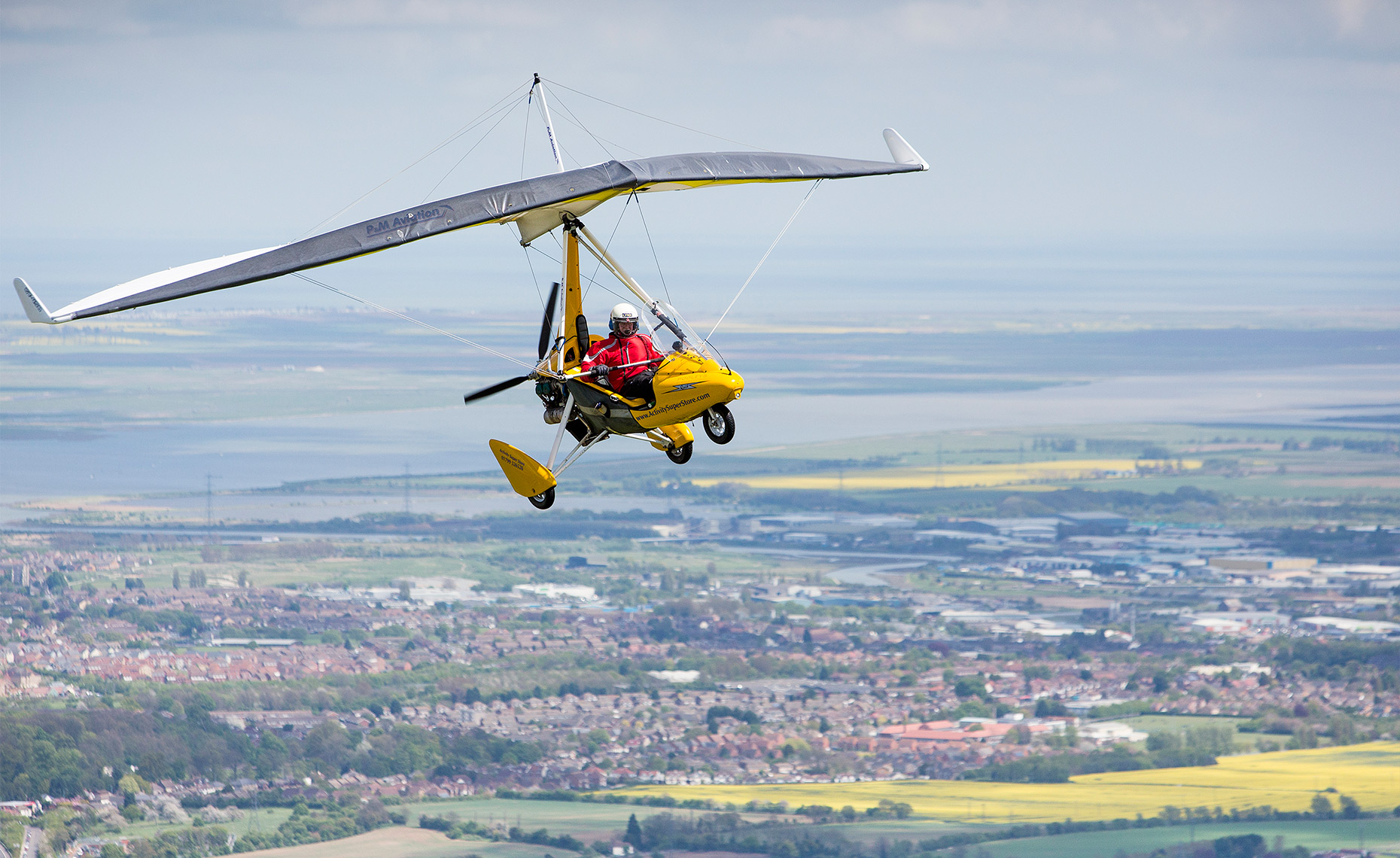  Air to air photography of a Microlight flying over Medway in Kent.