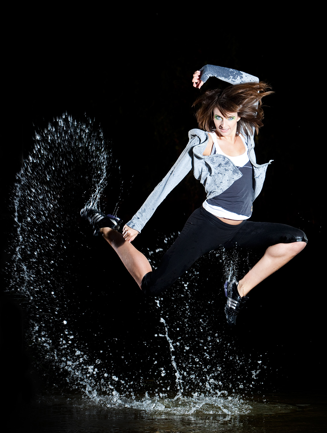 Editorial photographer of a contemporary dancer leaping from water.